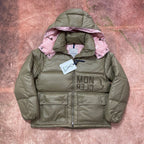 Olive green long puffer jacket with pink hood lining, quilted front and snap pockets.