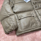 Olive green puffer jacket with flap chest pocket, quilted fabric and snap buttons.