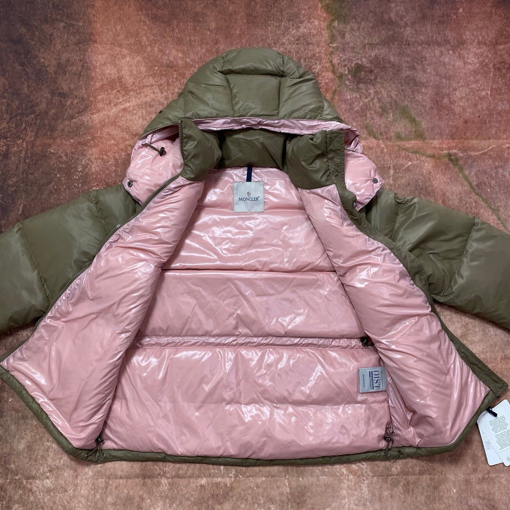 Olive green and pink hooded puffer jacket, showing pink insulated lining and hood.