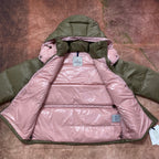 Olive green and pink hooded puffer jacket, showing pink insulated lining and hood.