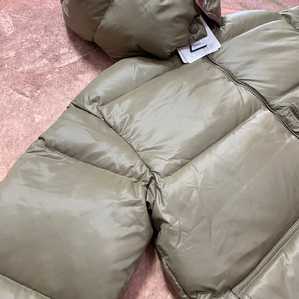 Olive green puffer jacket with center zipper, ribbed trim and quilted padded panels.