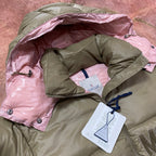 Olive green and pink hooded puffer jacket with snap shoulder buttons and hang tag.
