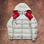 Moncler cream puffer jacket with red hood lining, zip front, and side drawcords