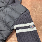Long puffer jacket sleeve and hem with ribbed knit stripes and circular logo patch