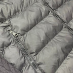 Quilted puffer jacket panel close-up with metal zipper and stitched channels