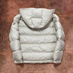 Moncler cream puffer jacket back view with hood, padded design, and quilted stripes