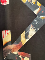 Black T-shirt close-up of X-shaped graphic with red and off-white label details