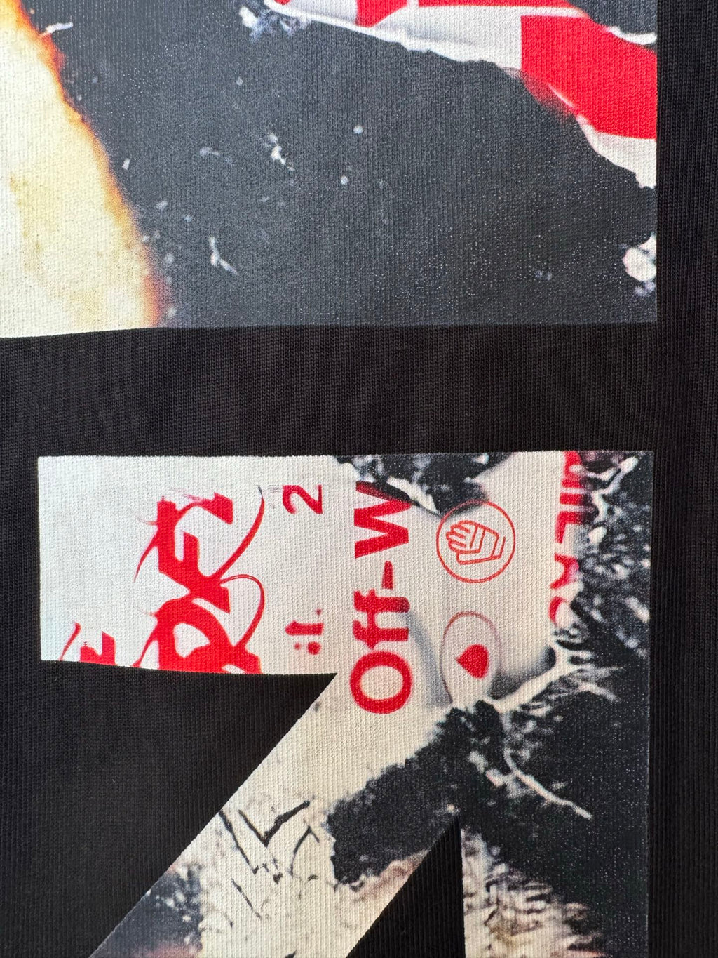 Black T-shirt fabric close-up with red Off-White™ text and circular logo