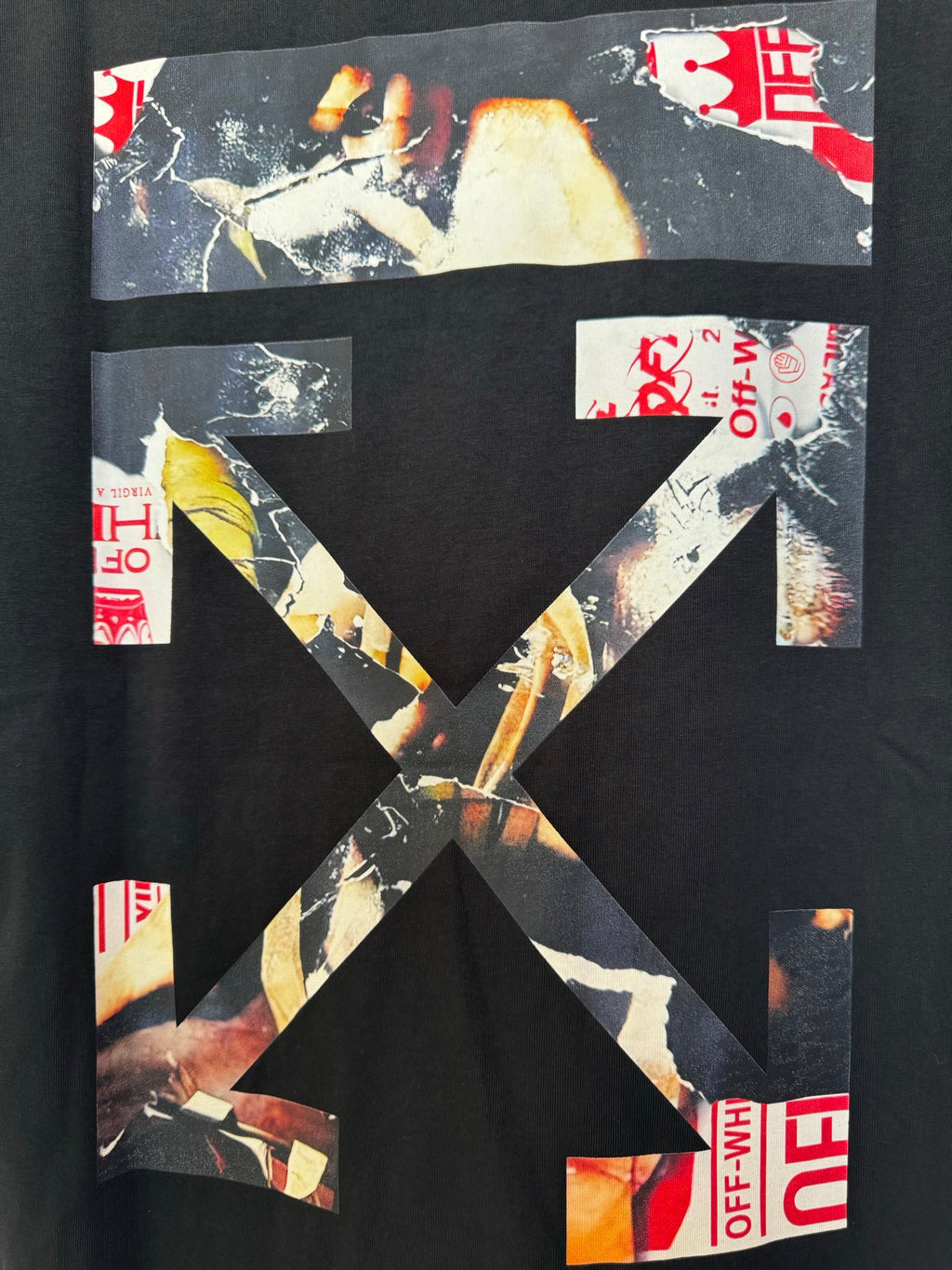 Black T-shirt graphic close-up with large X-style collage and red details