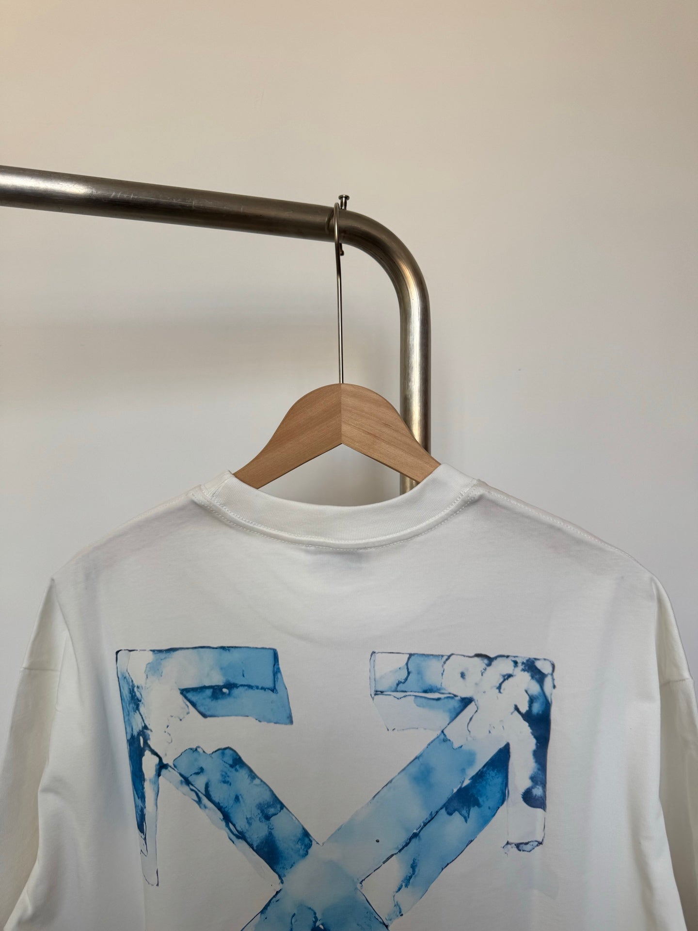 Off-white T-shirt with large blue 'X' graphic print, crew neck