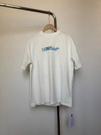 Off-white T-shirt with small blue logo graphic on chest