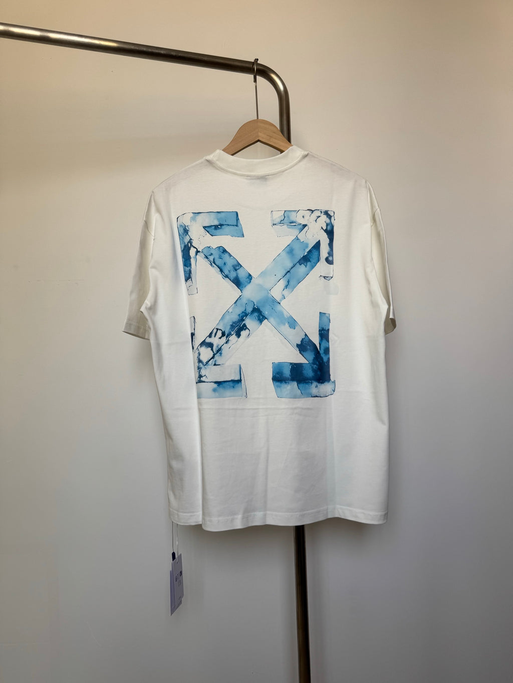 Off-white T-shirt with large blue 'X' graphic print
