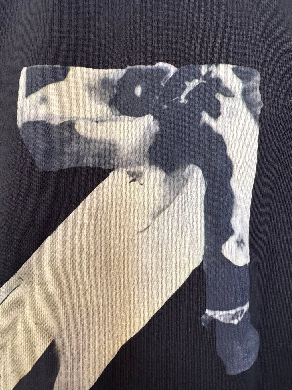 Dark T-shirt close-up of Off-White X graphic on back panel