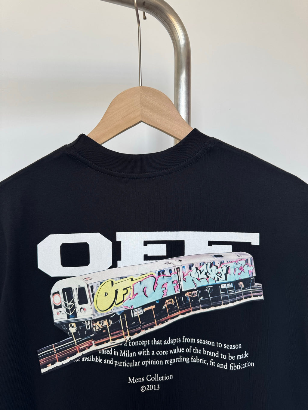 Off White T-shirt in dark color with white 'Off' logo and train graphic