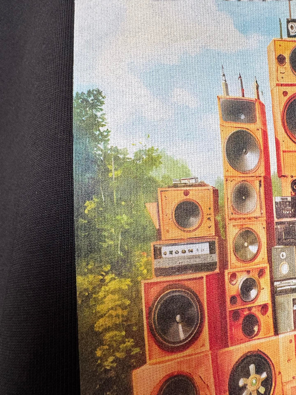 Off White T-shirt graphic close-up with orange speaker tower