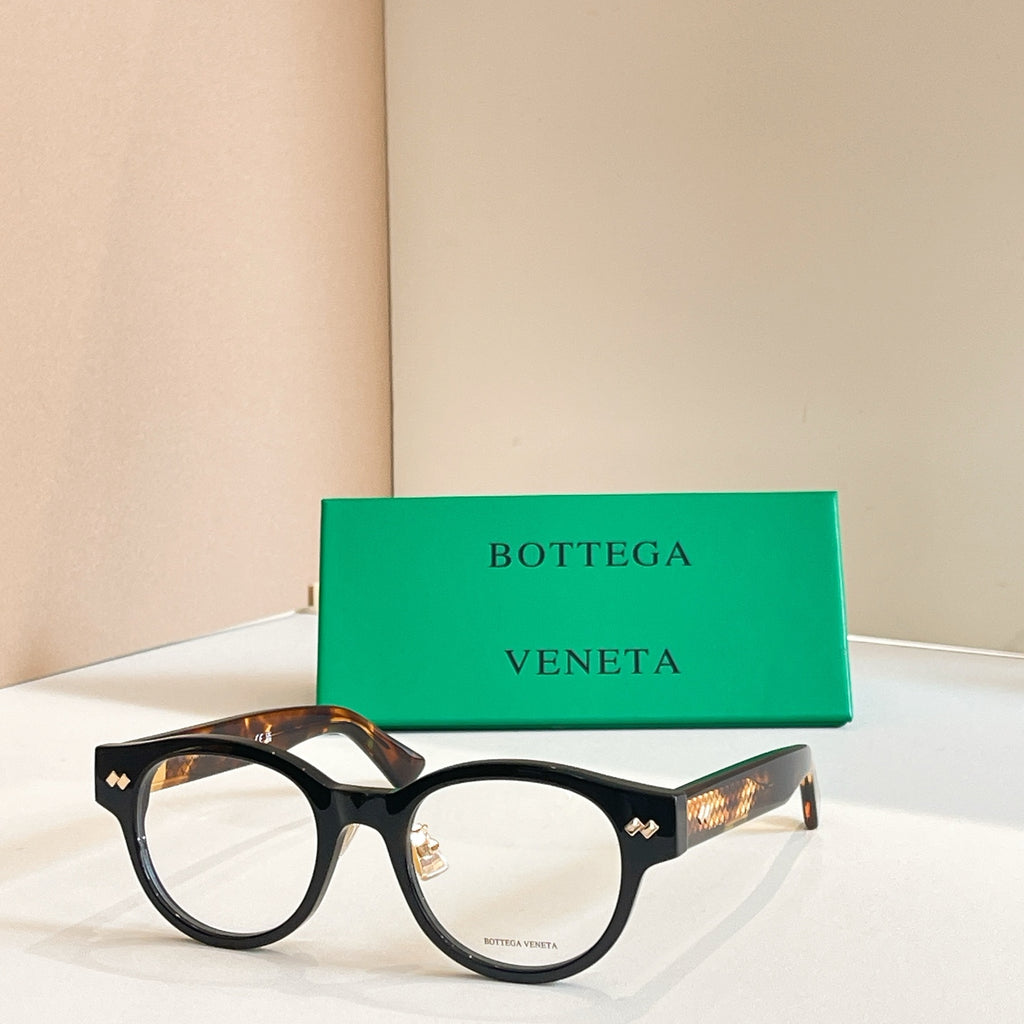 Eyeglasses with black frames and gold patterned temple ends