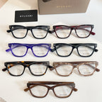 Multi-color eyeglass frames set in black, red, blue, and brown with BVLGARI logos.