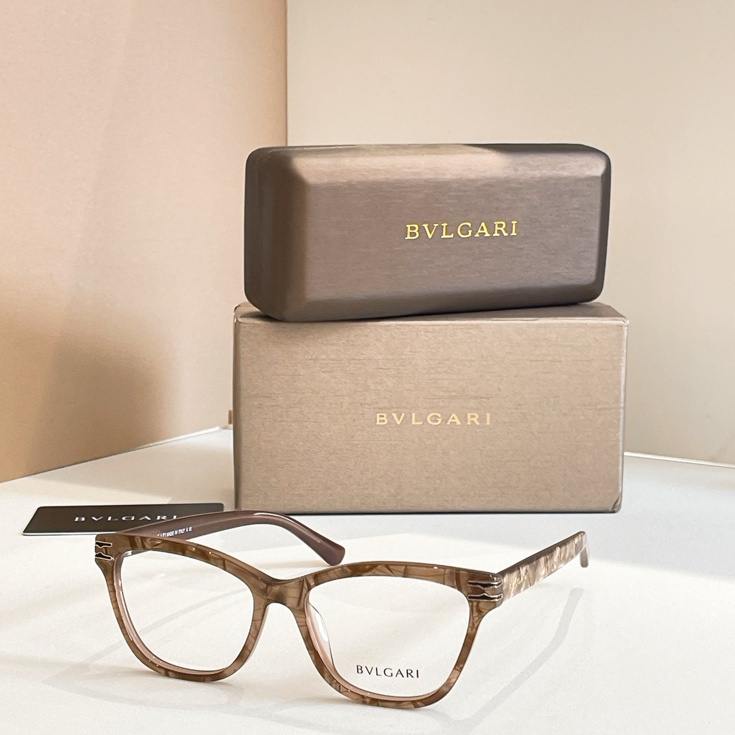 Eyeglass frames with tortoiseshell acetate and clear lenses, BVLGARI front logo.