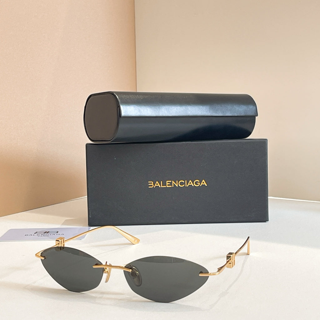 Balenciaga sunglasses with dark lenses and gold metal frame, metal temples