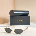 Balenciaga sunglasses with dark lenses and gold metal frame, metal temples