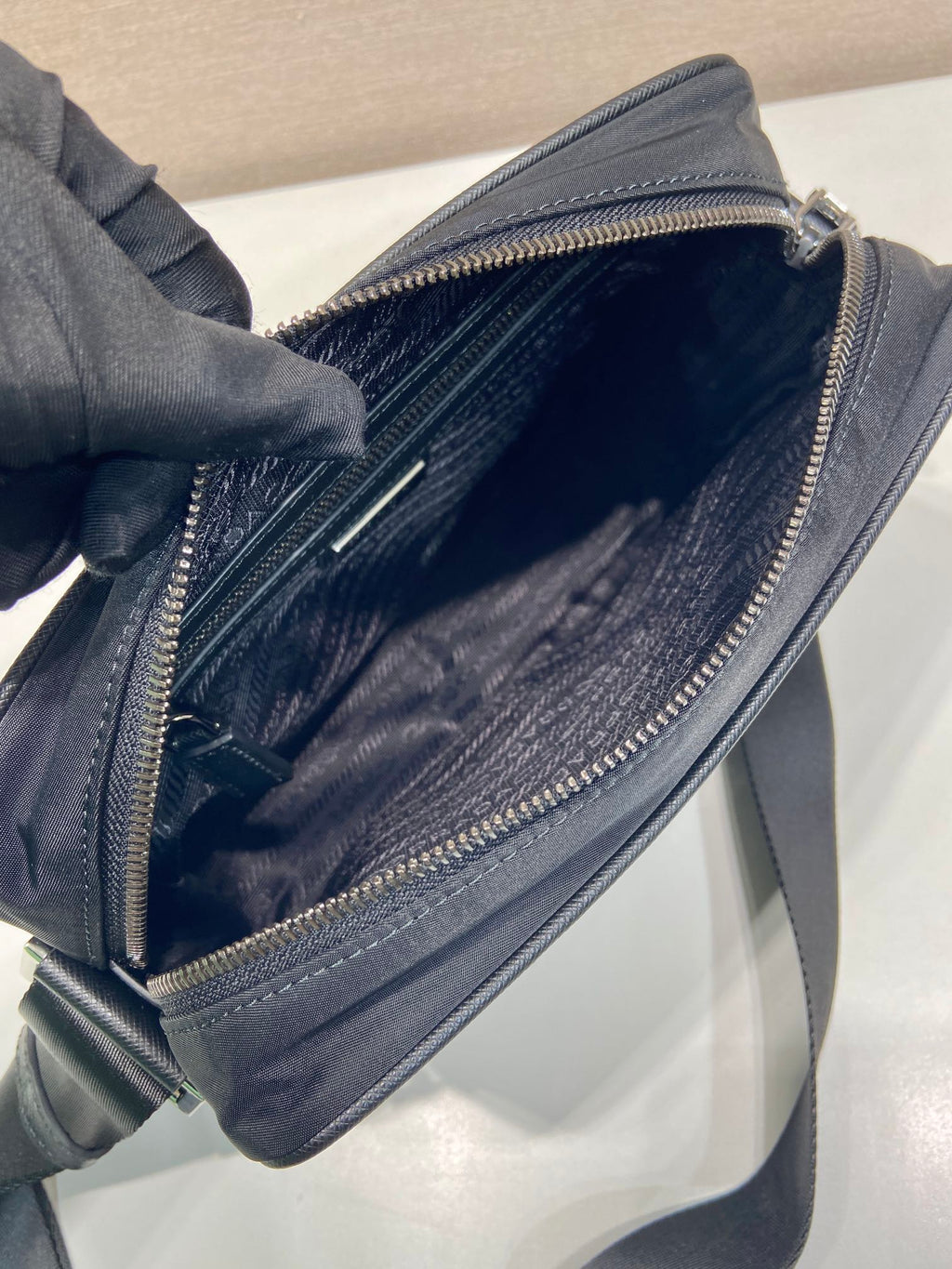 Dark blue crossbody bag open with zipper pocket and fabric lining