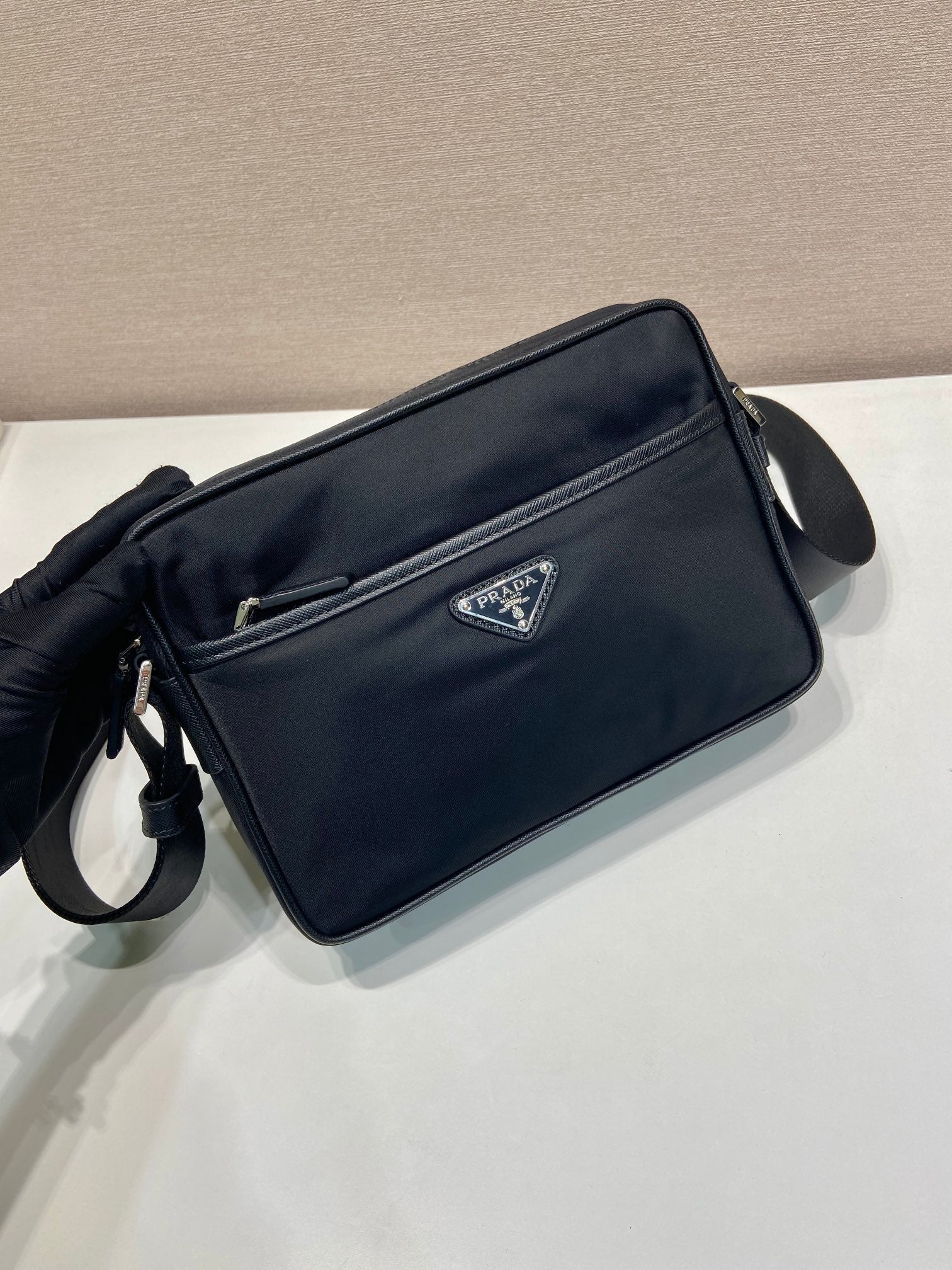 Dark blue crossbody bag with adjustable strap and front zip pocket