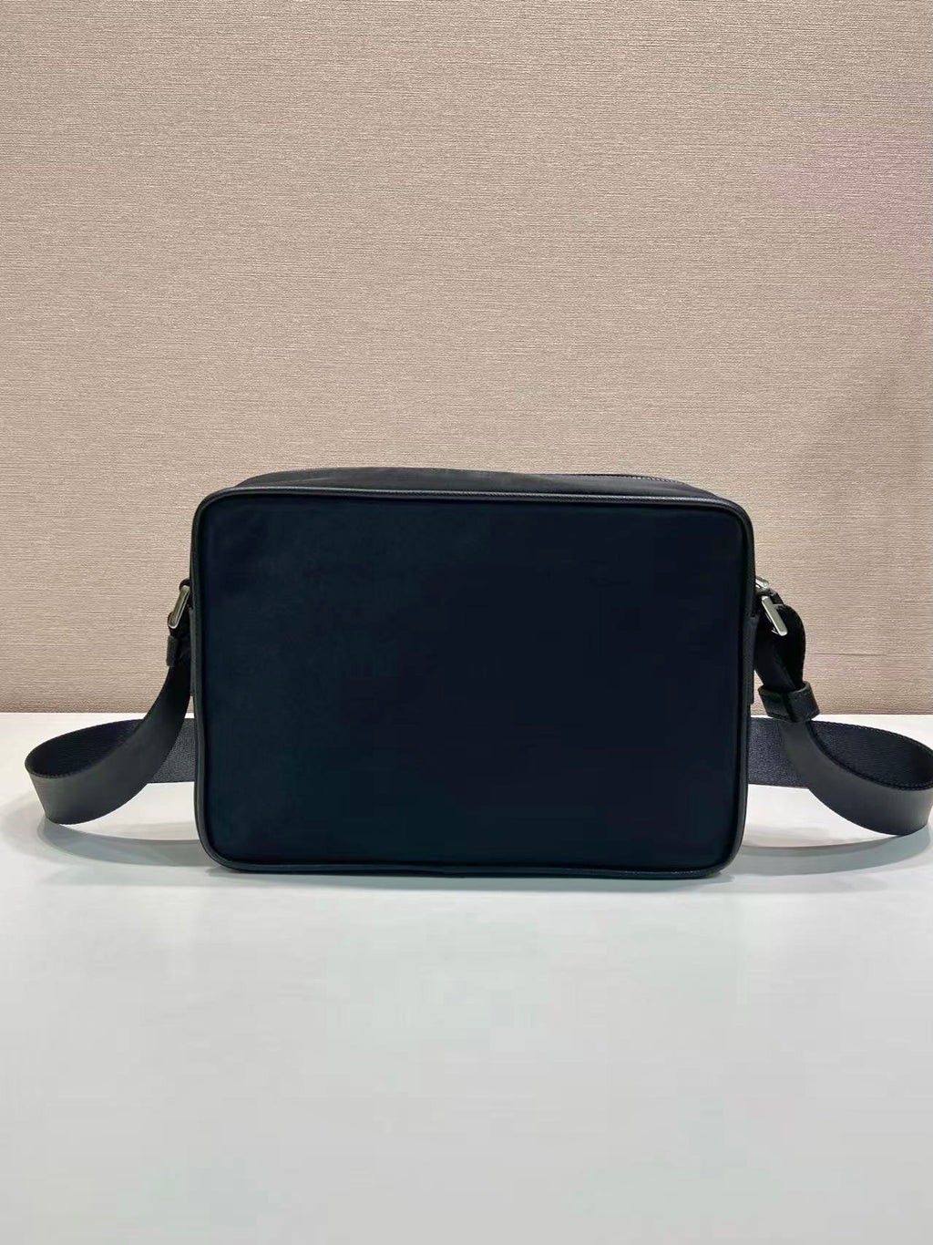 Dark blue rectangular shoulder bag with top handle and side crossbody straps