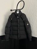 Long black puffer jacket with hood, snap buttons, and Moncler chest patch