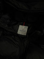 Moncler logo care tag on black puffer jacket lining
