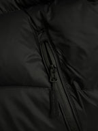 Black puffer jacket with visible zipper track and side seam detail