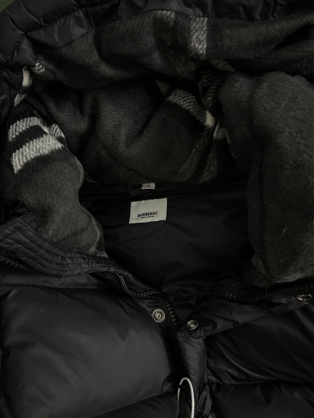Black puffer jacket hood lining with inner placket and snap buttons
