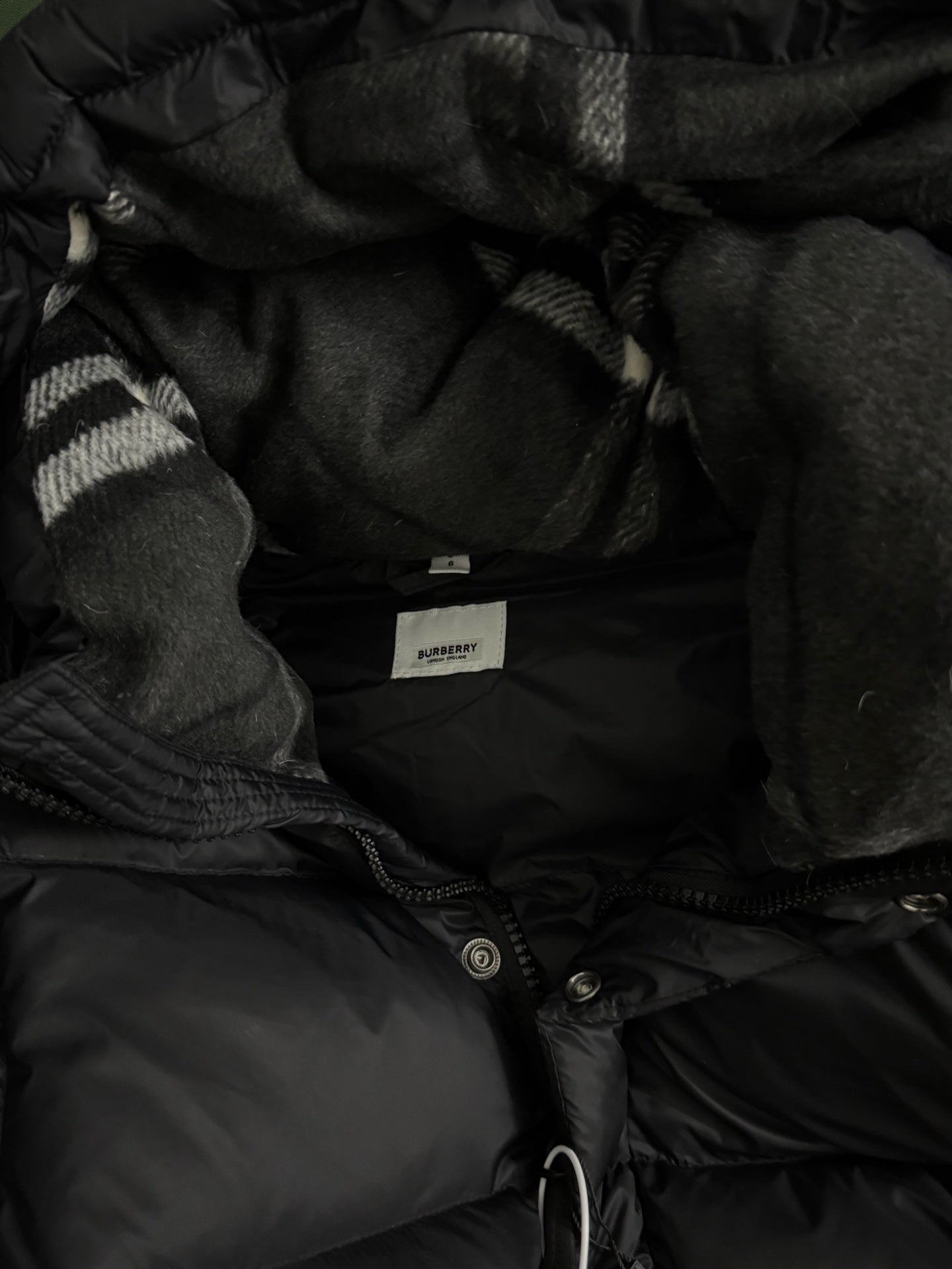 Black puffer jacket hood lining with inner placket and snap buttons
