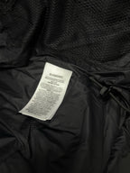 Black puffer jacket care label card attached inside lining