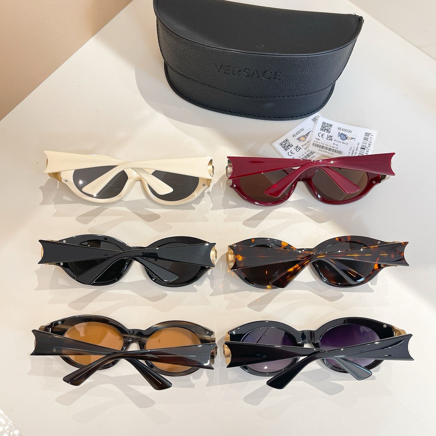 Set of Versace sunglasses with mixed frames: white, red, black, and tortoiseshell