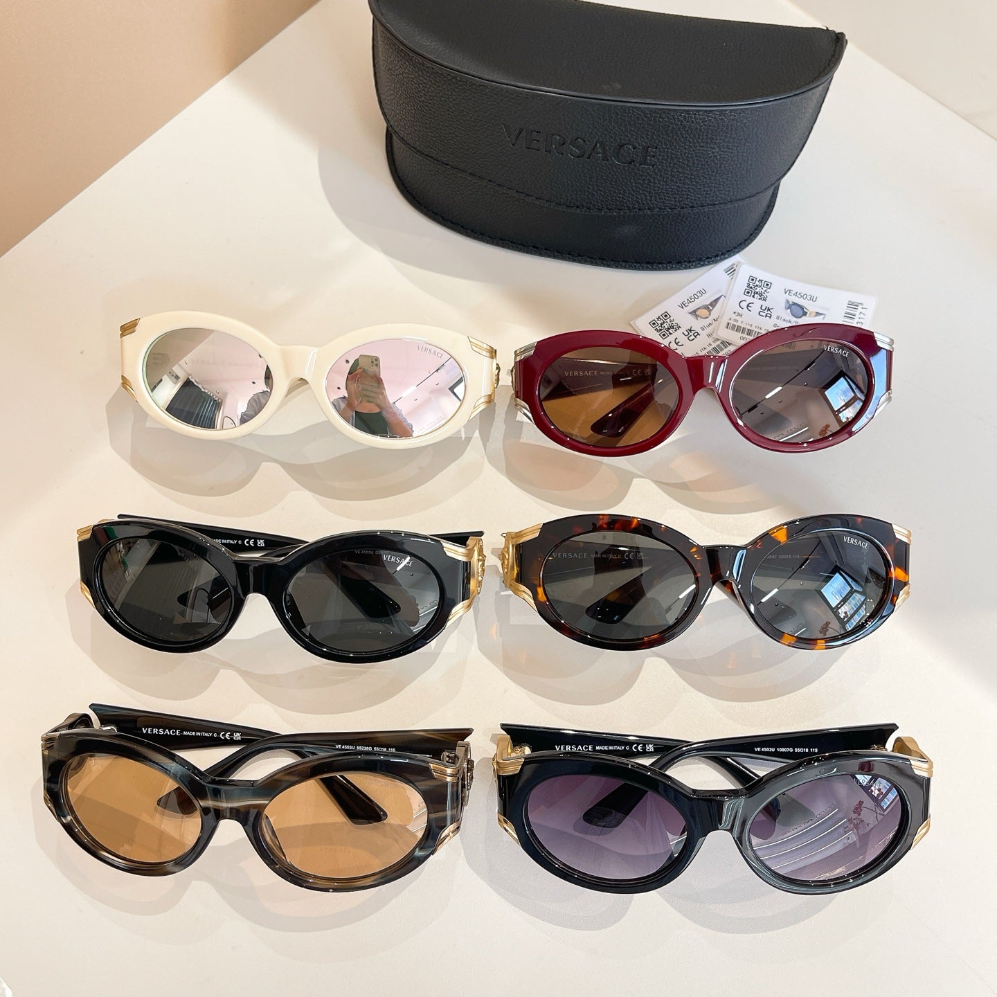 Set of Versace sunglasses in assorted frames: white, red, black, and tortoiseshell