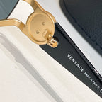 Gold temple hinge with engraved detail on sunglasses with dark arms