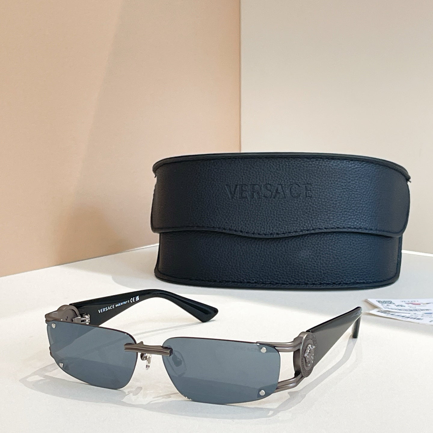 Blue-lens sunglasses with black frames and black case