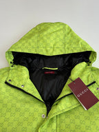 Lime green hooded puffer jacket with black lining, Gucci hang tag visible