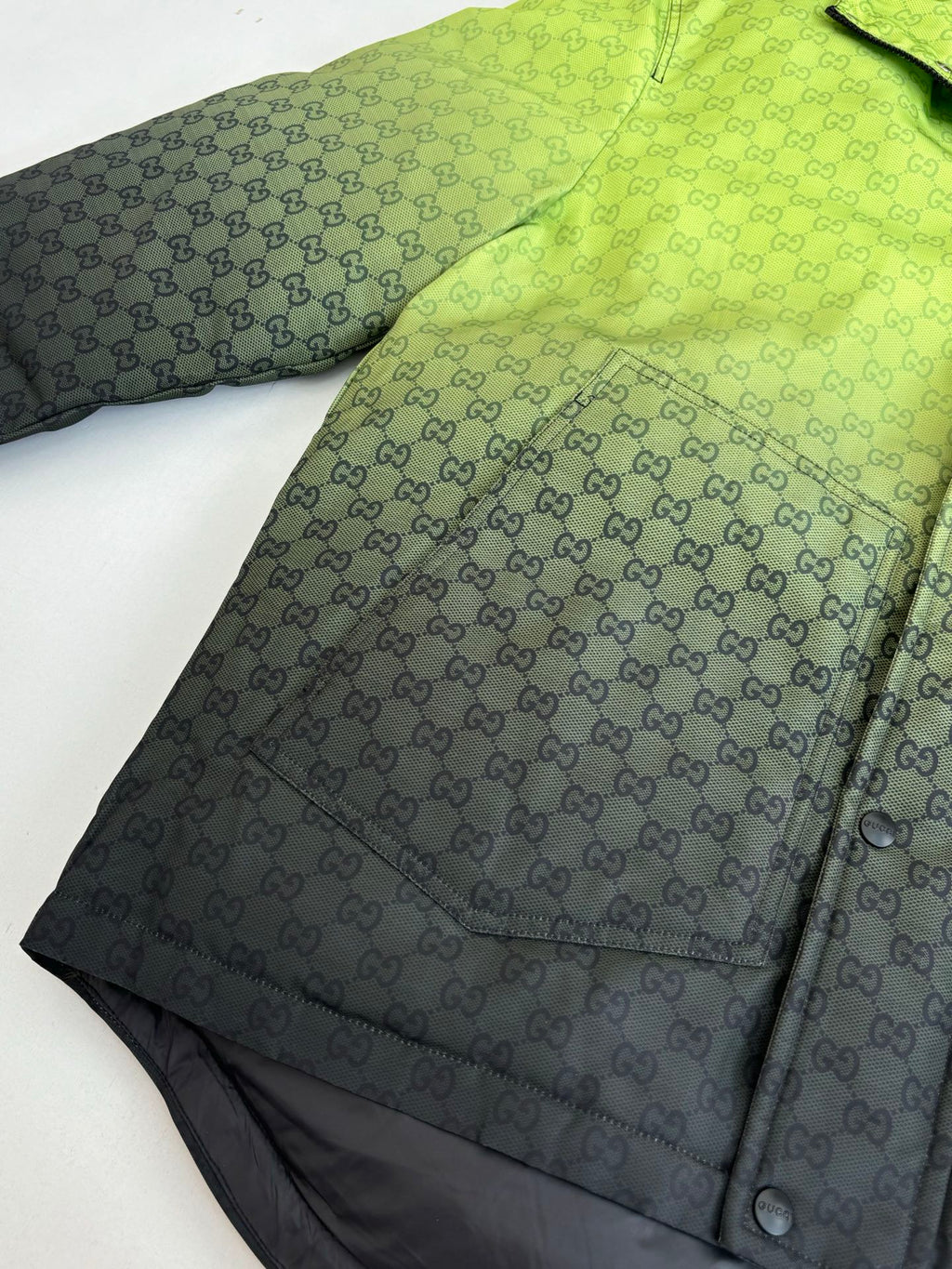 Lime green GG-pattern hooded puffer jacket panel with button snap detail