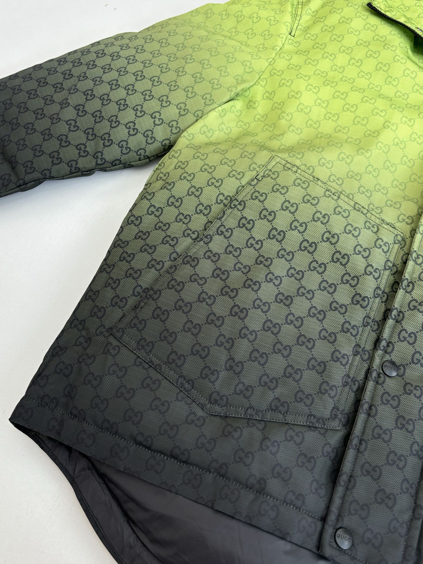 Lime green GG-pattern hooded puffer jacket panel with button snap detail