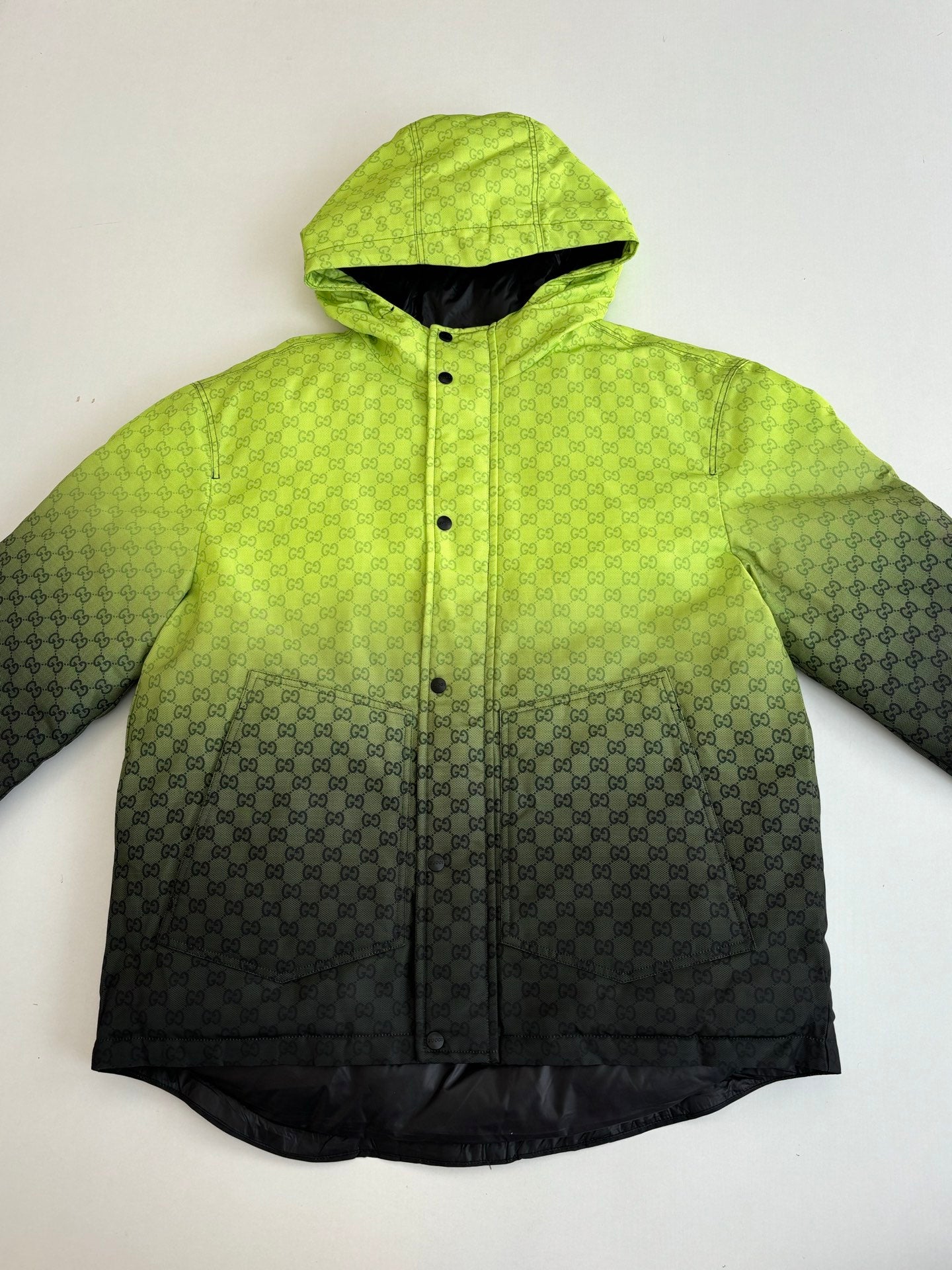 Lime green hooded puffer jacket with dark lower half and button closure