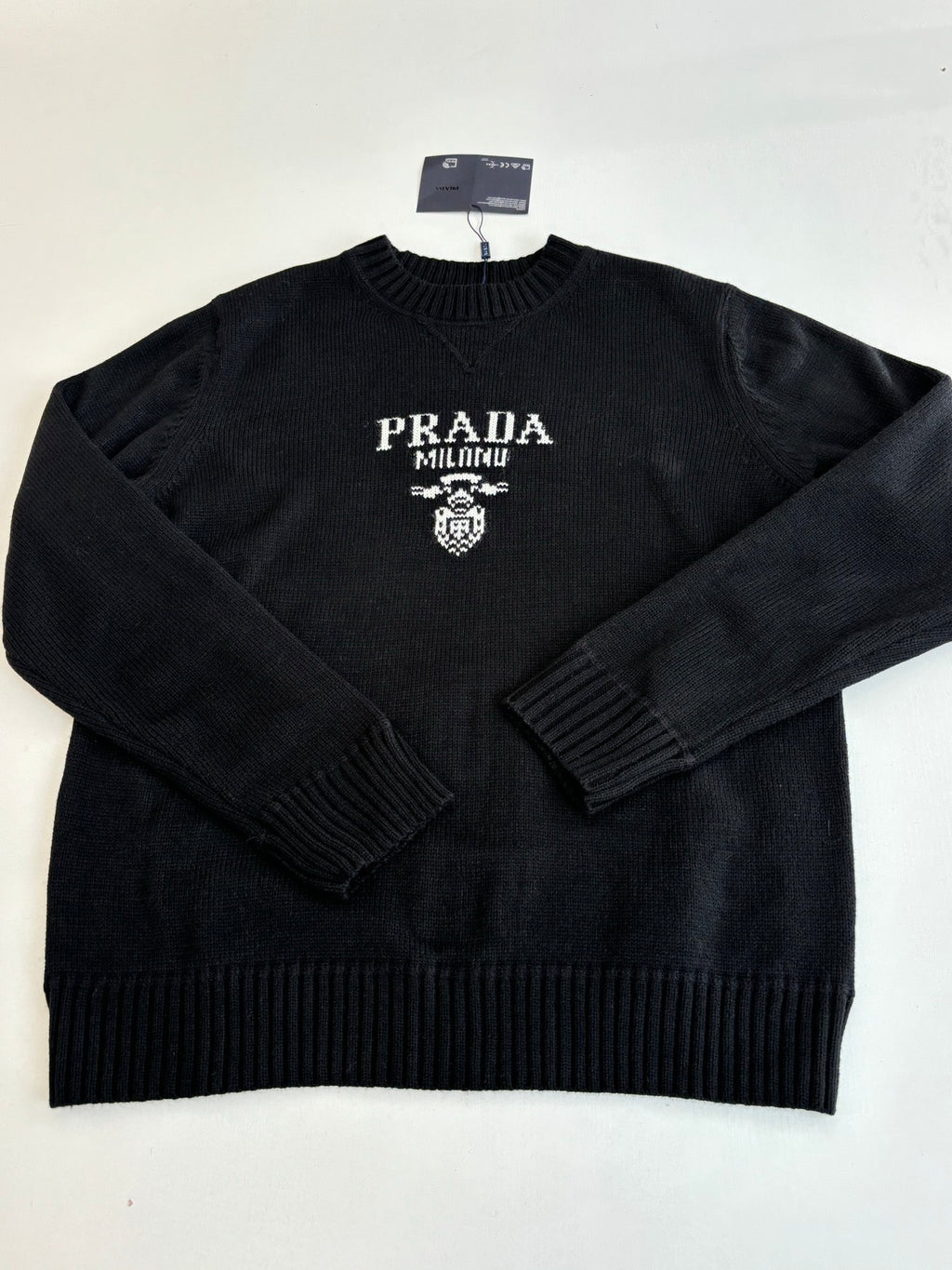 Black knit crewneck sweater with PRADA MILANO logo and crest