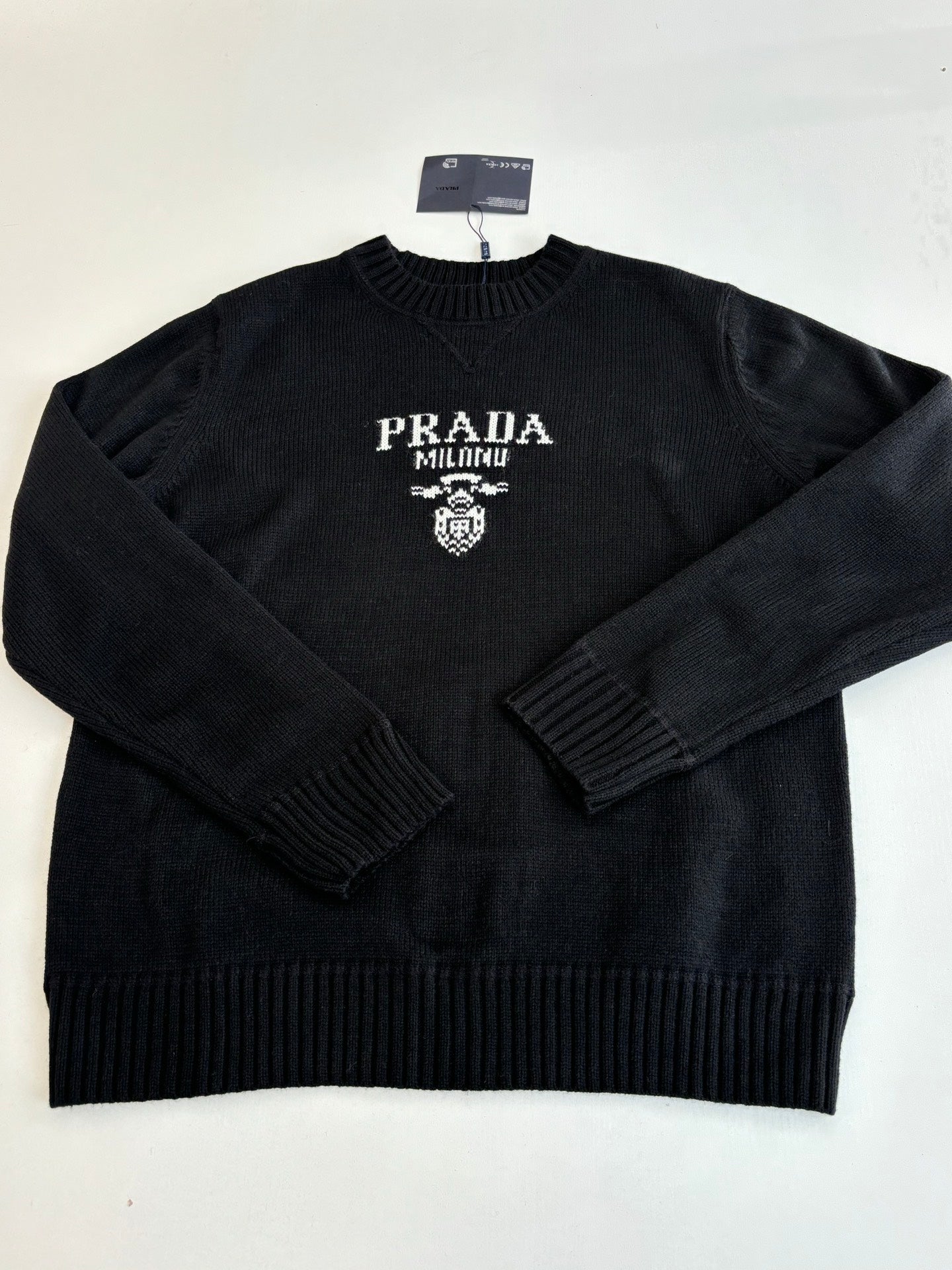 Black knit crewneck sweater with PRADA MILANO logo and crest