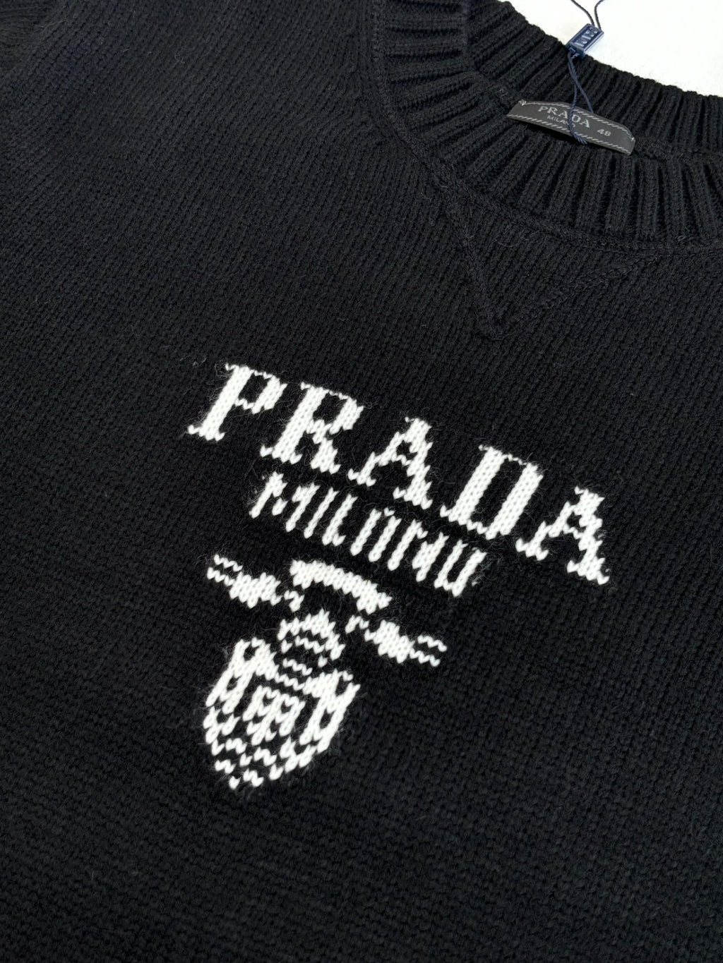 Black knit sweater with PRADA MILANO crest and lettering detail