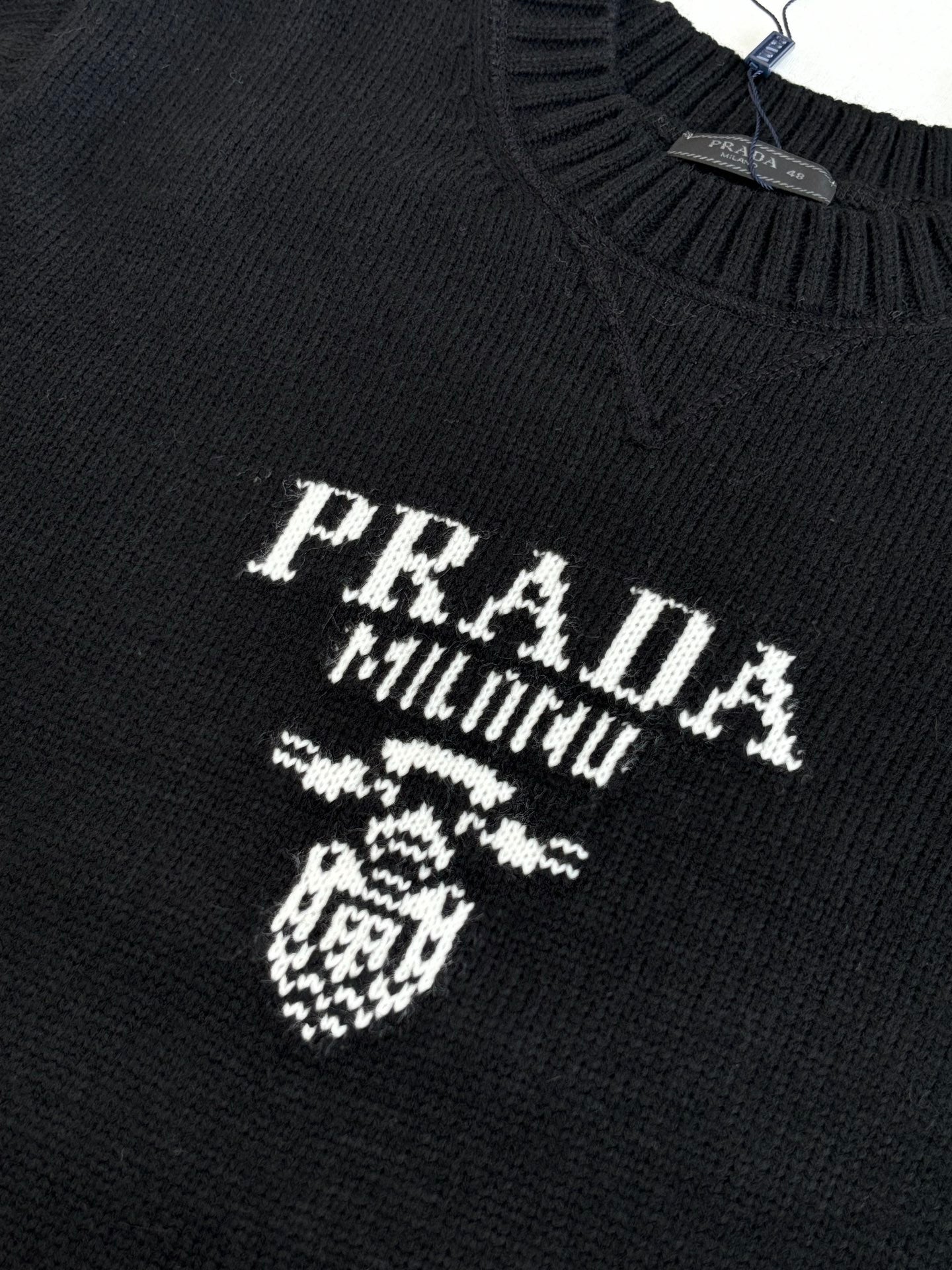 Black knit sweater with PRADA MILANO crest and lettering detail