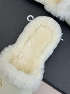 Chanel women's fur slide close-up, cream textured footbed and side strap