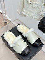 Chanel women's fur slides, cream and black, two shoes on black box