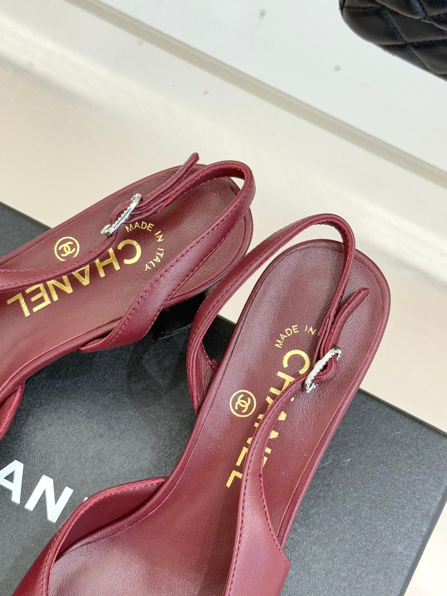 Chanel ladies slingback pumps close-up, burgundy leather with gold “CHANEL” lining