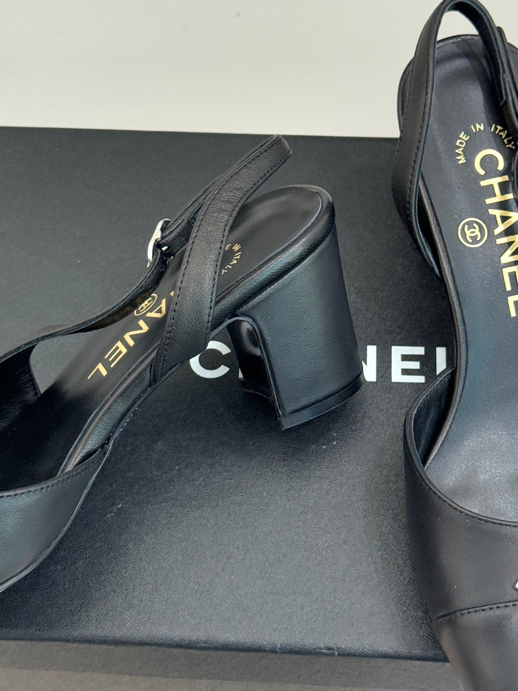 Close-up of black leather slingback heel with CHANEL branding on insole