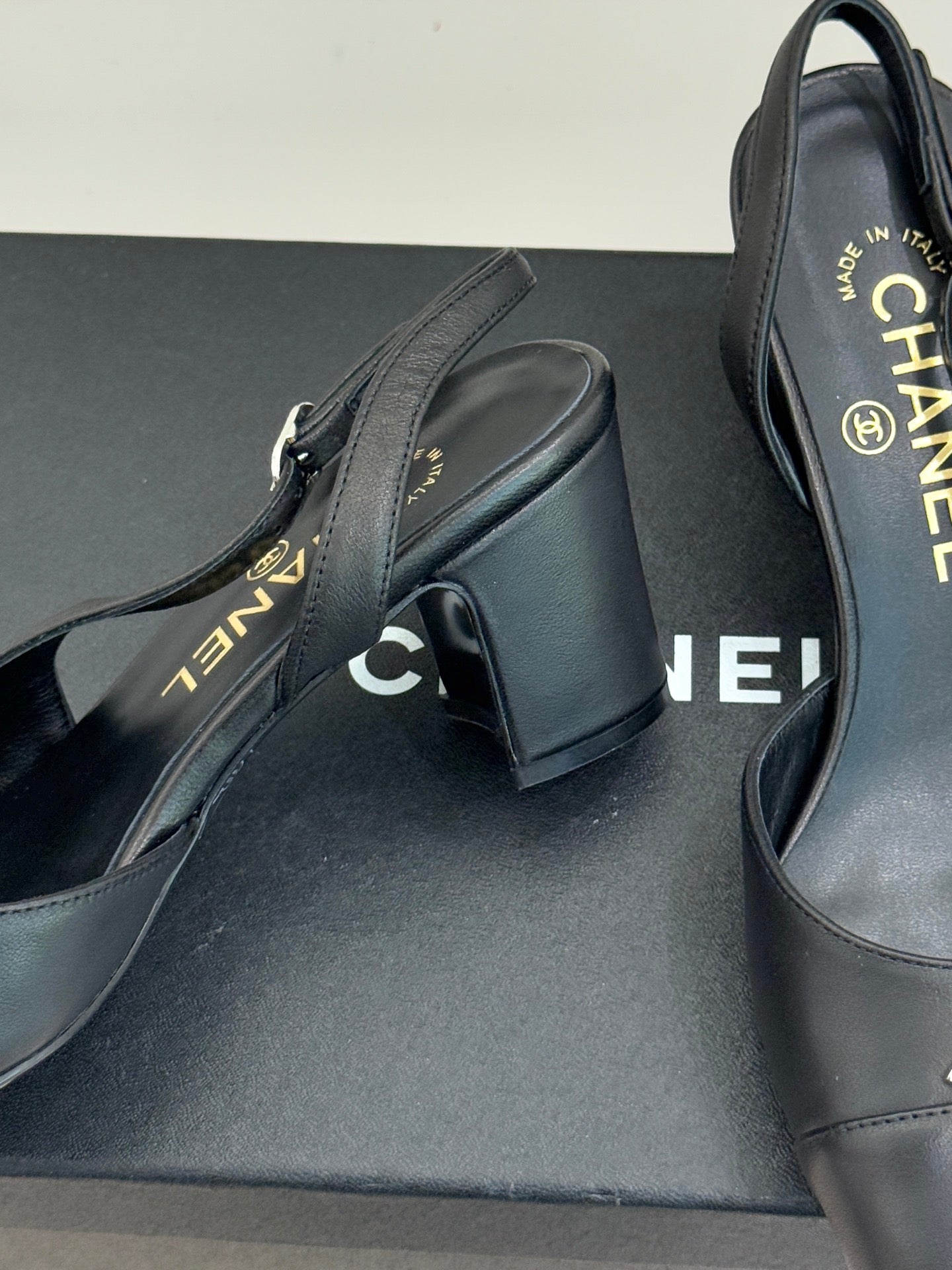 Close-up of black leather slingback heel with CHANEL branding on insole